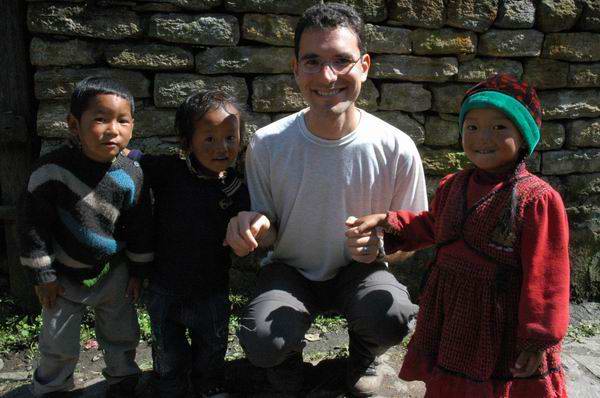 The children enthusiastically run to greet us, grabbing our little fingers, and joining us as we walk down the village street.