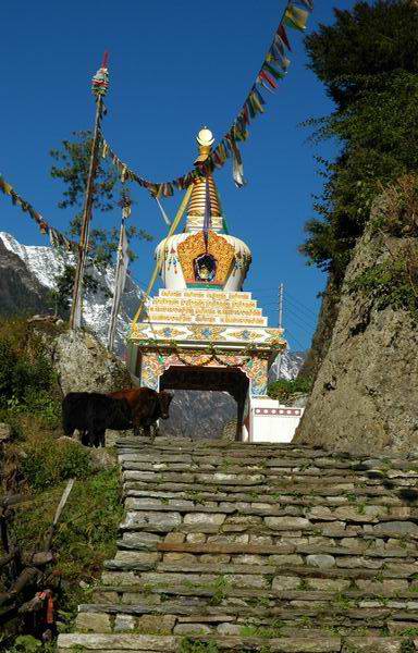 Beautiful Buddhist Chorten with colourful paintings and prayer wheels inside.