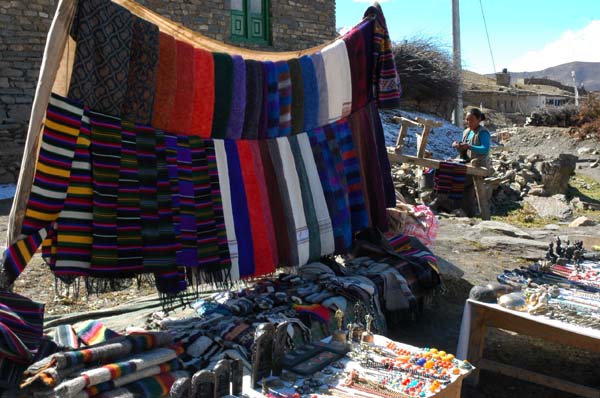 The barren landscape is coloured by the many trailside-stands of handwoven scarves, belts and various handicrafts