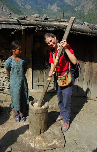 Lauri tests out the local tools used to separate the rice from the chaff