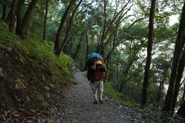 Manoj carrying our heavy load up the hill