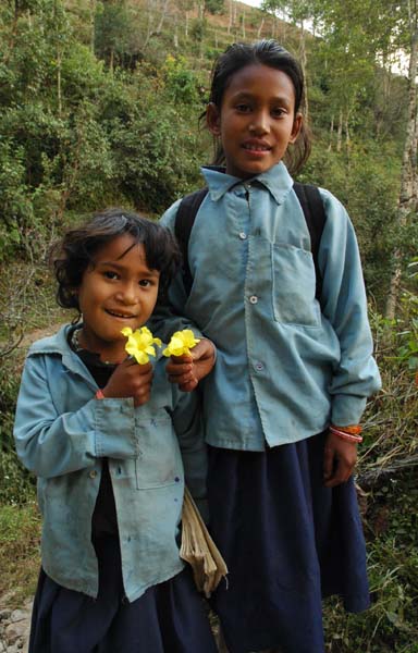 School girls, who run to meet us, and offer us flowers