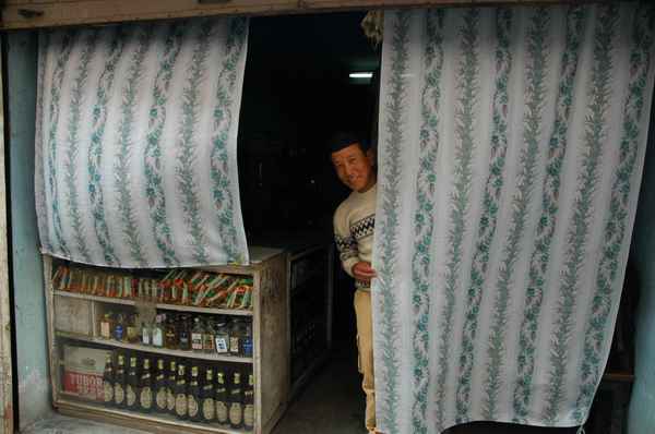 Dawa, peeking outside the curtain of his tea house, where we were invited to meet his family one afternoon