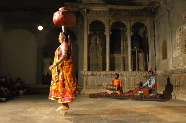 This women is amazing. She begins with one heavy pot and progresses to a total of nine, in the next photo.